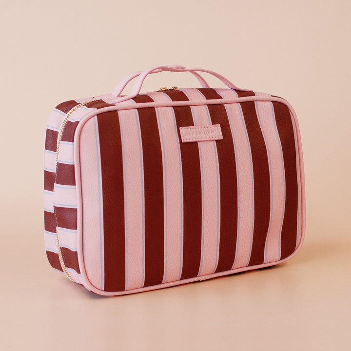 Fox and fallow Striped toiletry bag with a visible brand logo on a beige background