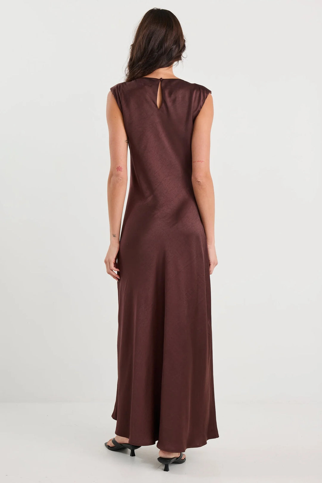 Brown dress worn by a person on a white background