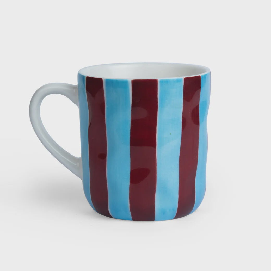 Mug with blue and red striped design on a white background