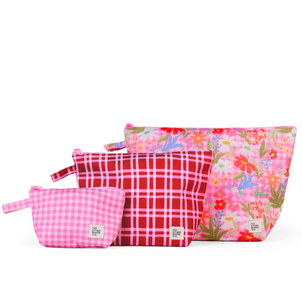 Set of three pink pouches with different patterns on a white background