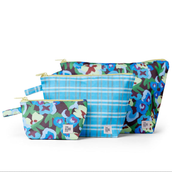 Set of three colorful pouches with floral and plaid patterns on a white background
