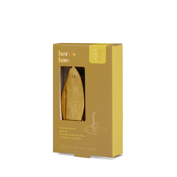 Gold citrus juicer in a 'here's how' branded box on a white background