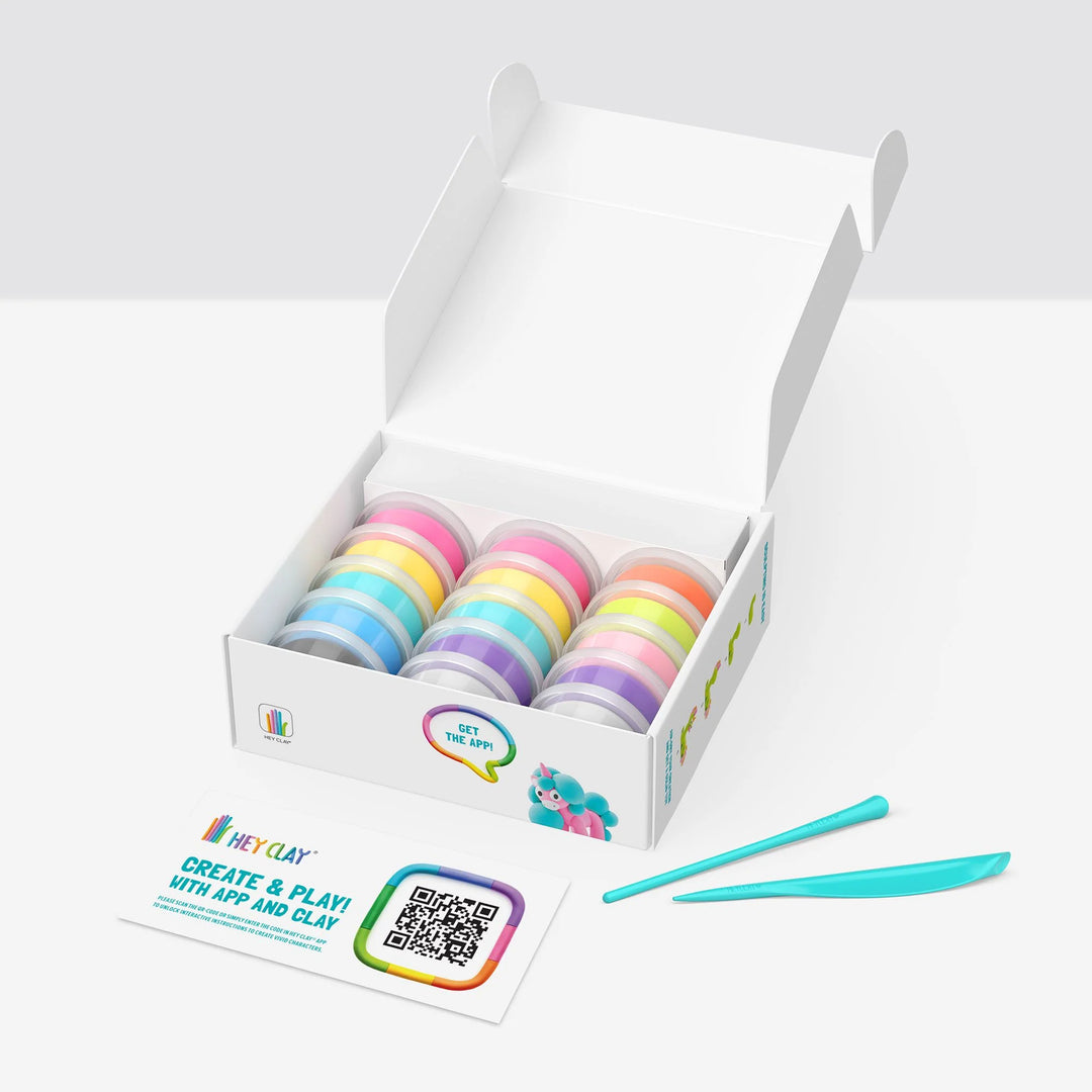 Box of colorful clay rolls with a tool on a white background