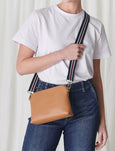 Our Hudson Cross Body Bag combines style and function with two removable straps: a classic PU strap with gold chain and a playful striped webbing strap. Available from www.thecollectivenz.com