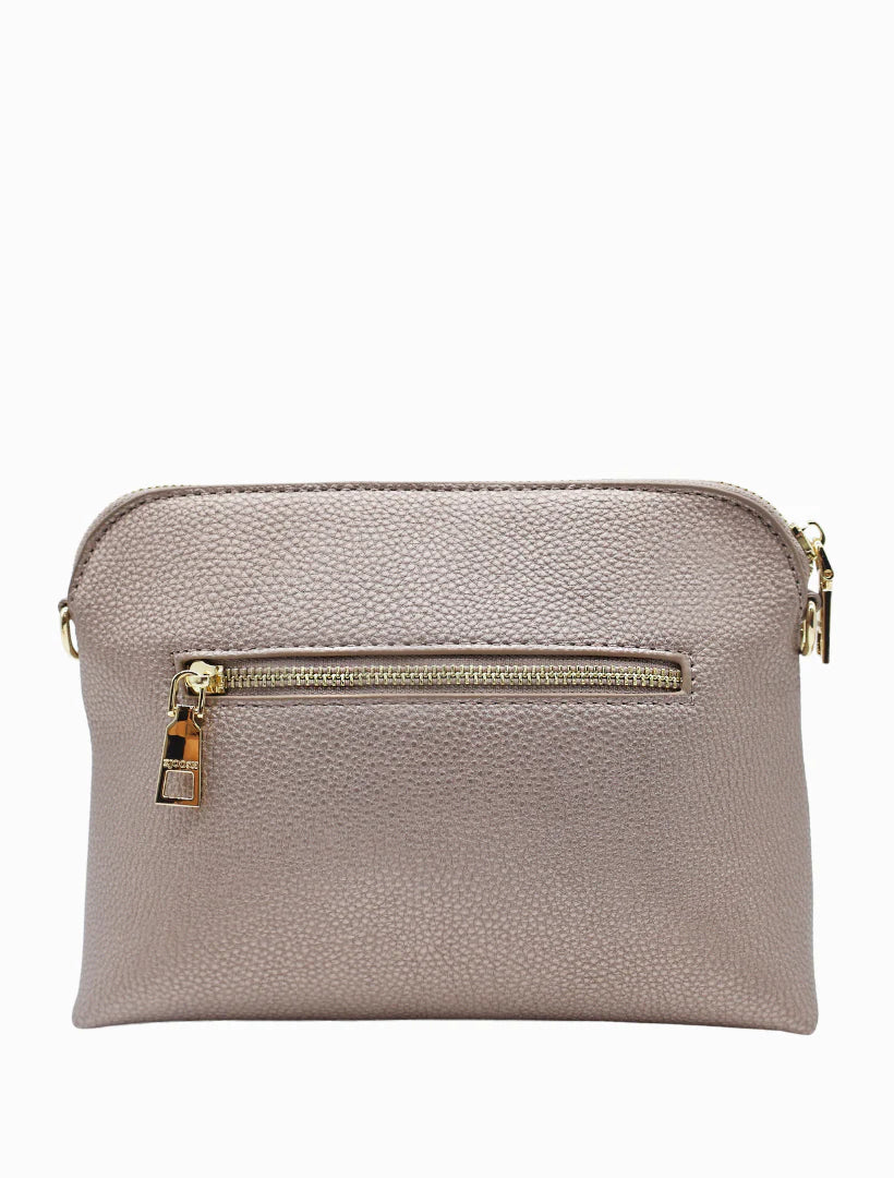 Our Hudson Cross Body Bag combines style and function with two removable straps: a classic PU strap with gold chain and a playful striped webbing strap. Available from www.thecollectivenz.com