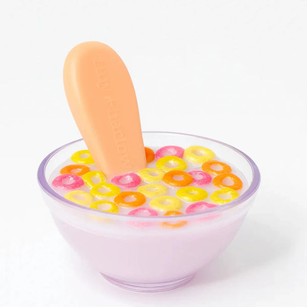 dolls Glass bowl with colorful cereal and a popsicle on a white background
