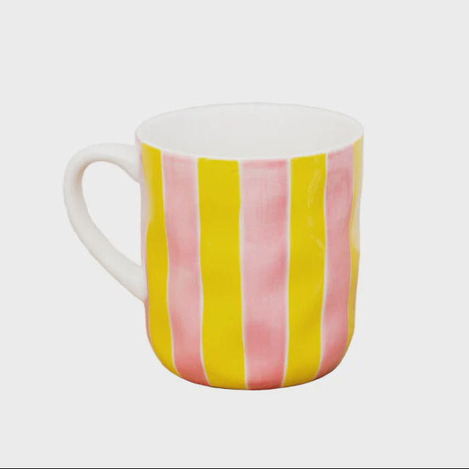 Mug with pink and yellow vertical stripes on a white background