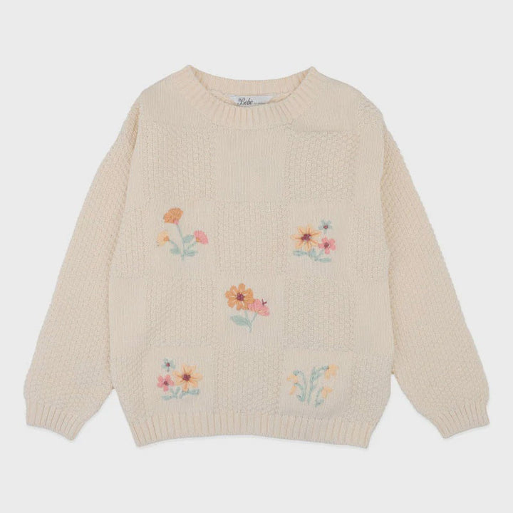 Beige sweater with floral embroidery on a white background