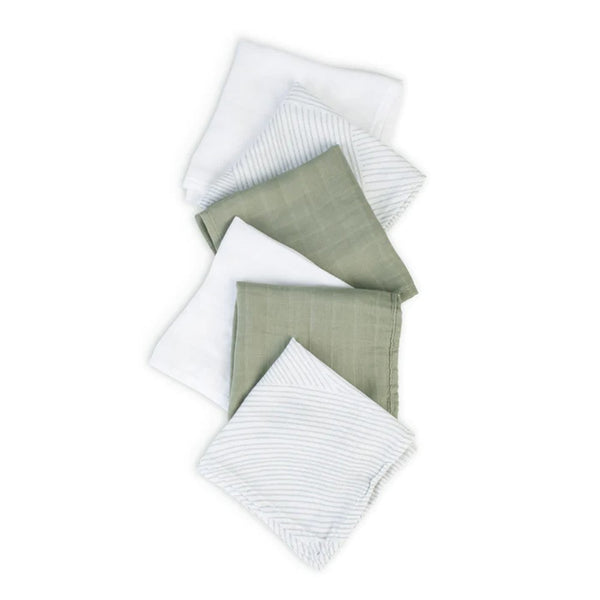 Set of four folded fabric swatches in white and green on a white background