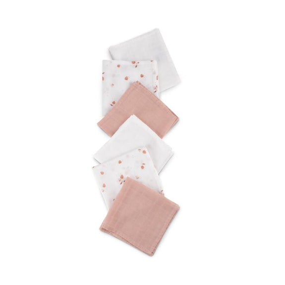 Set of pink and white baby burp cloths on a white background