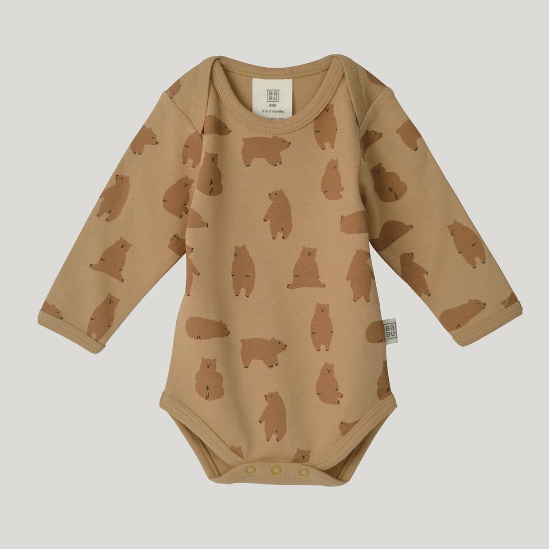 A long-sleeve baby bodysuit in a warm tan color, featuring an all-over print of brown bear silhouettes, laid flat against a light gray background.