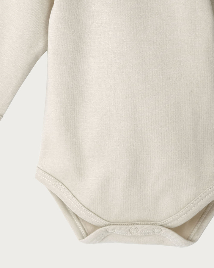 Organic Cotton Long Sleeve Bodysuit is a must-have for your baby's wardrobe. Made from super-soft organic cotton that's gentle on delicate skin, it’s perfect for sleeping and everyday wear, available from www.thecollectivenz.com
