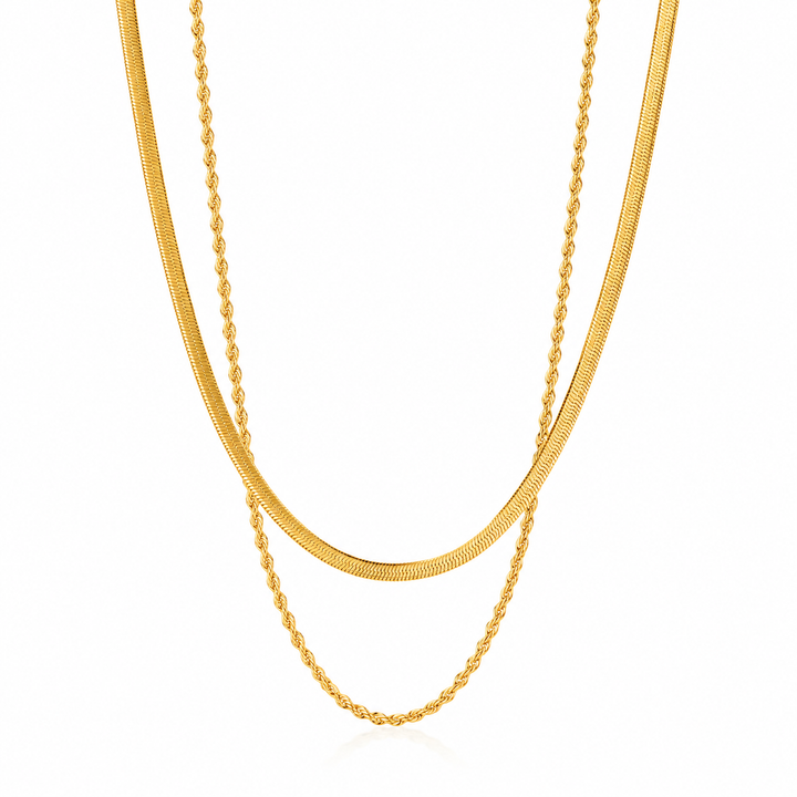 A double-layered gold chain necklace featuring a textured snake chain and a thinner twisted rope chain, displayed on a clean white background.