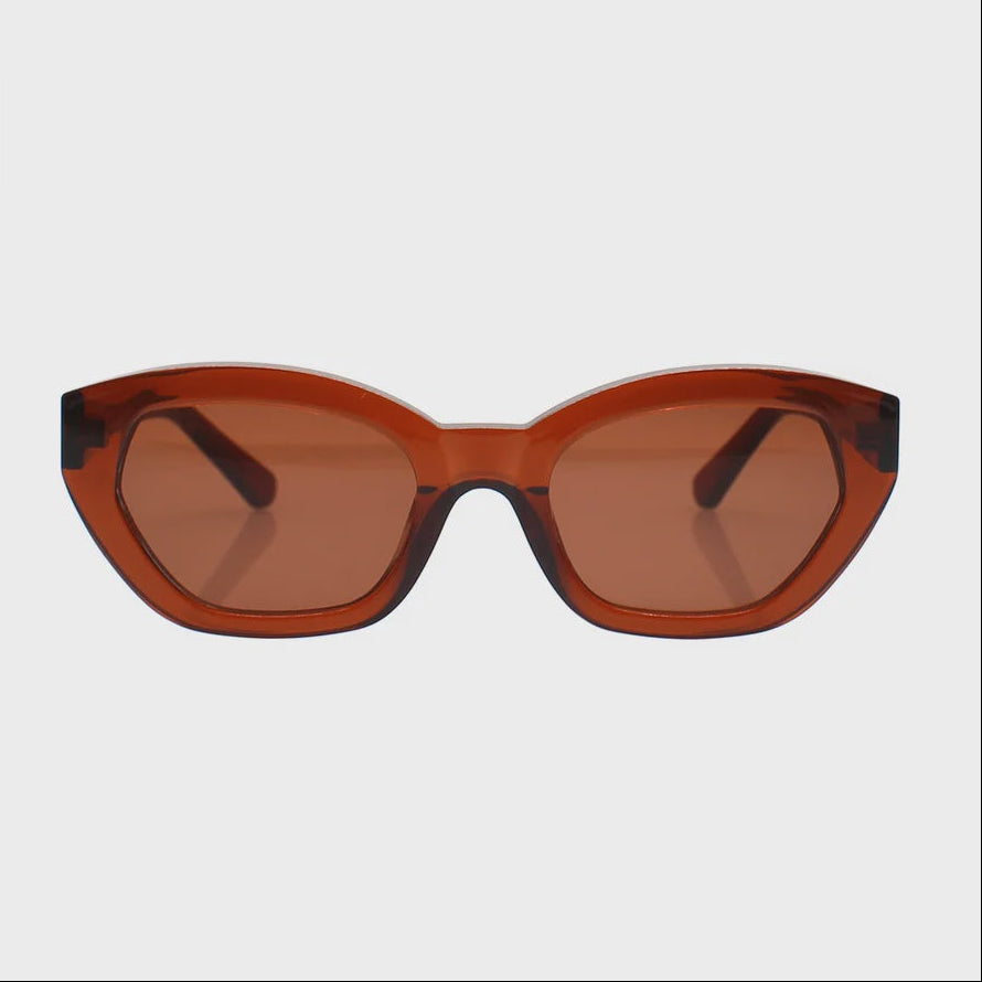 Cat-eye sunglasses with a translucent amber-brown frame and matching tinted lenses, shown against a light gray background.