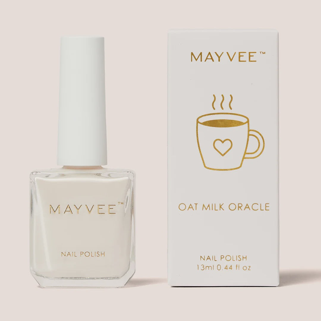 Mayvee Oat Milk Oracle nail polish bottle and its white packaging box with gold lettering, set against a solid pale pink background.