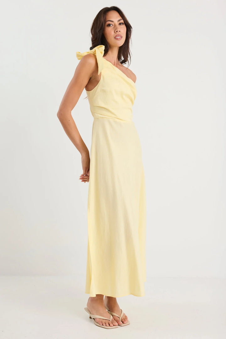 Woman wearing a yellow one-shoulder dress on a white background
