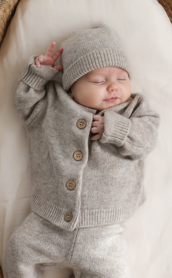 Wrap your little ones in the softness and warmth of our stunning Baby and Child Cardigan. Crafted from the finest 100% wool with a soft cashmere feel, In a rustic taupe colour this cardigan ensures a touch of luxury that's gentle on delicate skin. Available from www.thecollectivenz.com