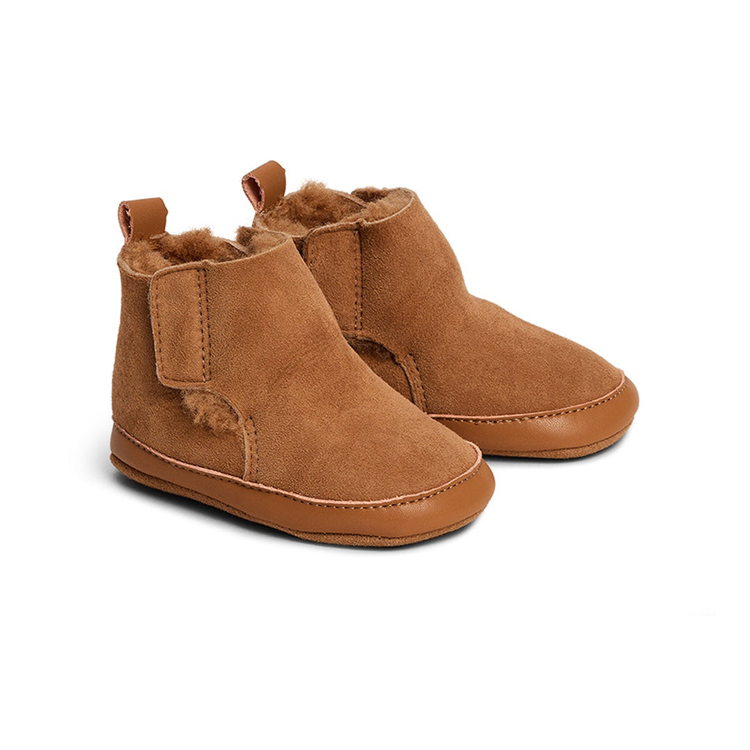 Pair of brown children's boots with fur lining on a white background