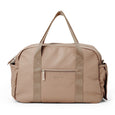 Pretty Brave beige nappy bag with multiple pockets and a handle on a white background