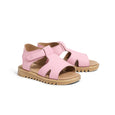 Pair of pink pretty brave sandals with brown soles on a white background