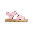 Pink pretty brave sandal with a tan sole on a white background