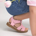 pretty brave Pink sandal worn by a child on a light gray background