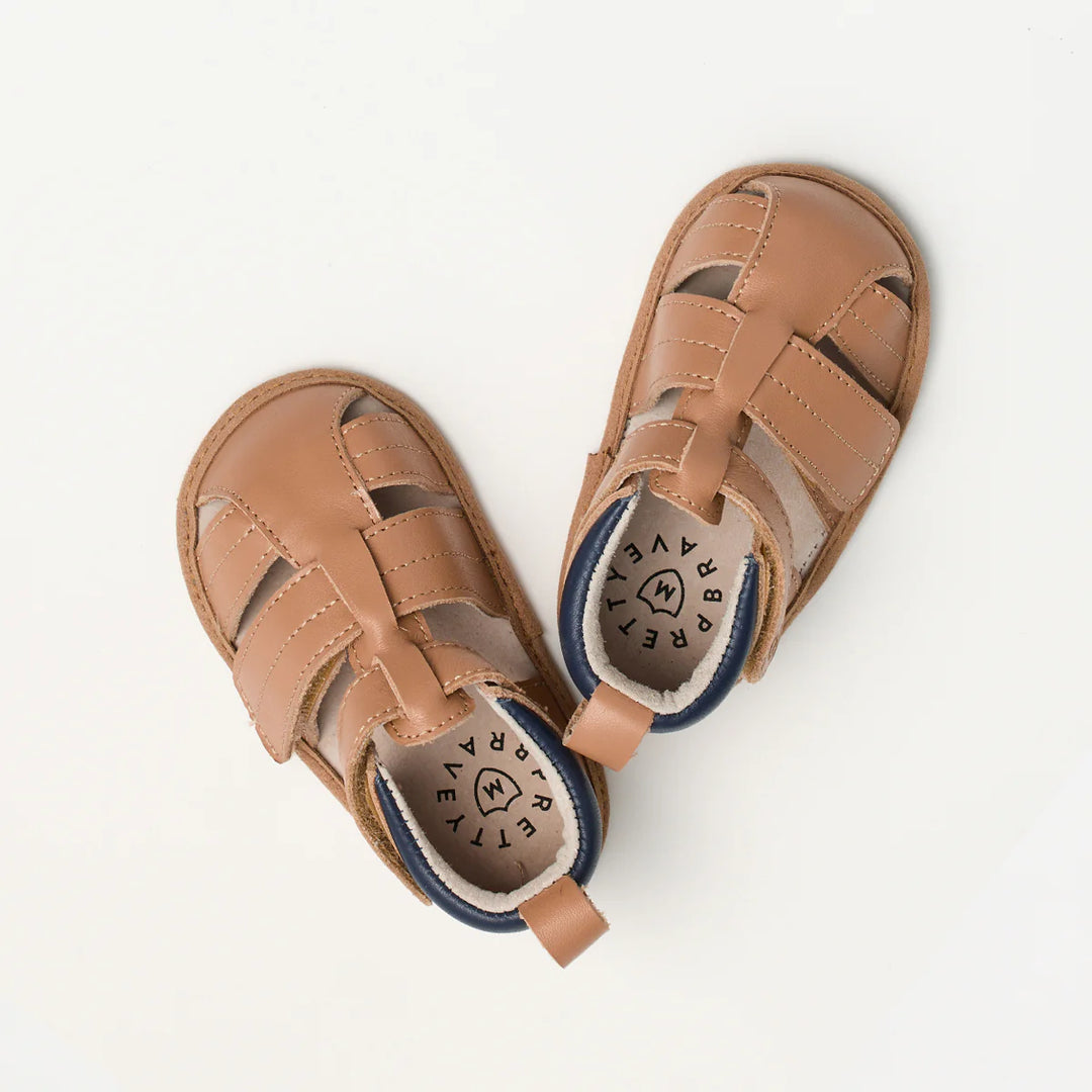 Pair of pretty brave brown baby sandals on a white background