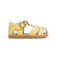 Yellow pretty brave sandal with a brown sole on a white background