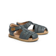 Pair of navy pretty brave sandals with brown soles on a white background