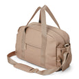 Pretty brave beige nappy bag with shoulder strap on a white background