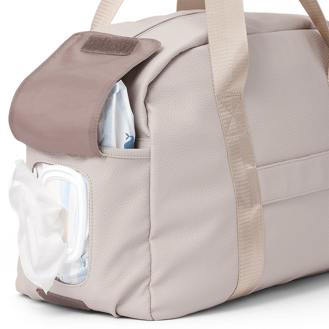 Pretty Brave stone diaper bag with a clear pocket showing a diaper and bottle.