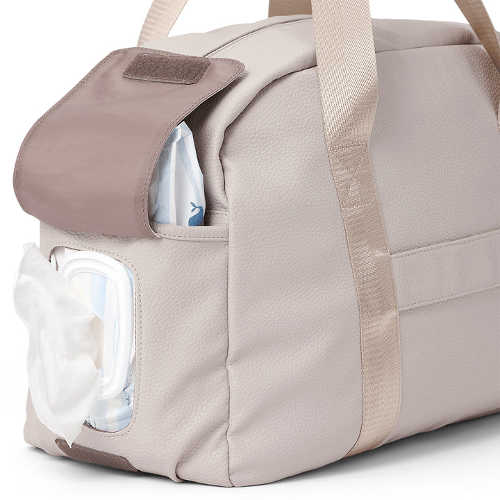 Pretty Brave stone diaper bag with a clear pocket showing a diaper and bottle.