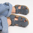 Children's pretty brave blue sandals with brown soles on a light background
