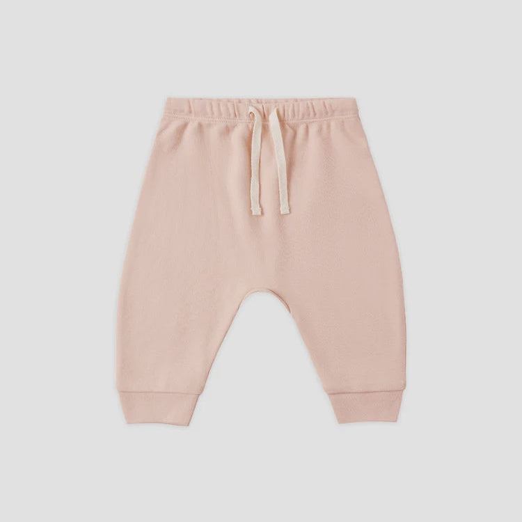 A pair of light pink jogger pants with a drawstring waist and elastic cuffs, shown flat on a light gray background.