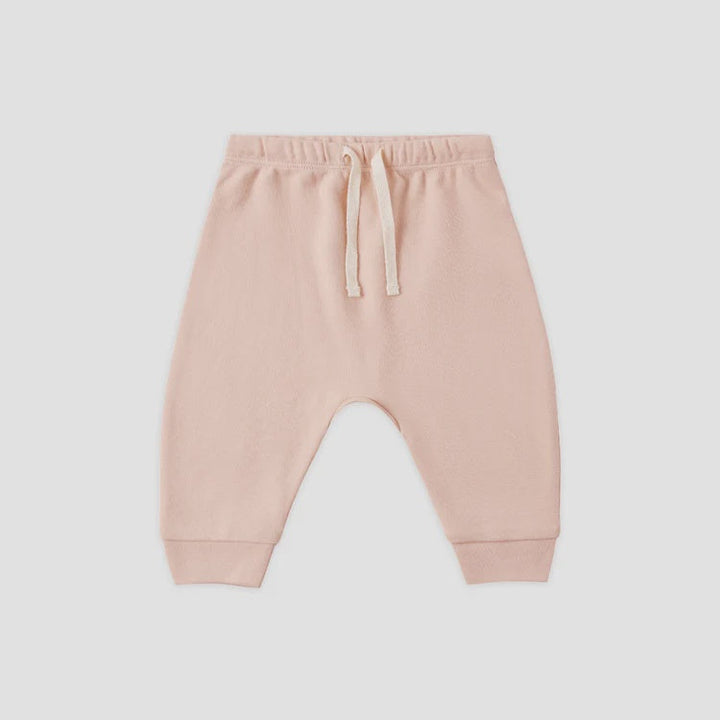 A pair of light pink jogger pants with a drawstring waist and elastic cuffs, shown flat on a light gray background.