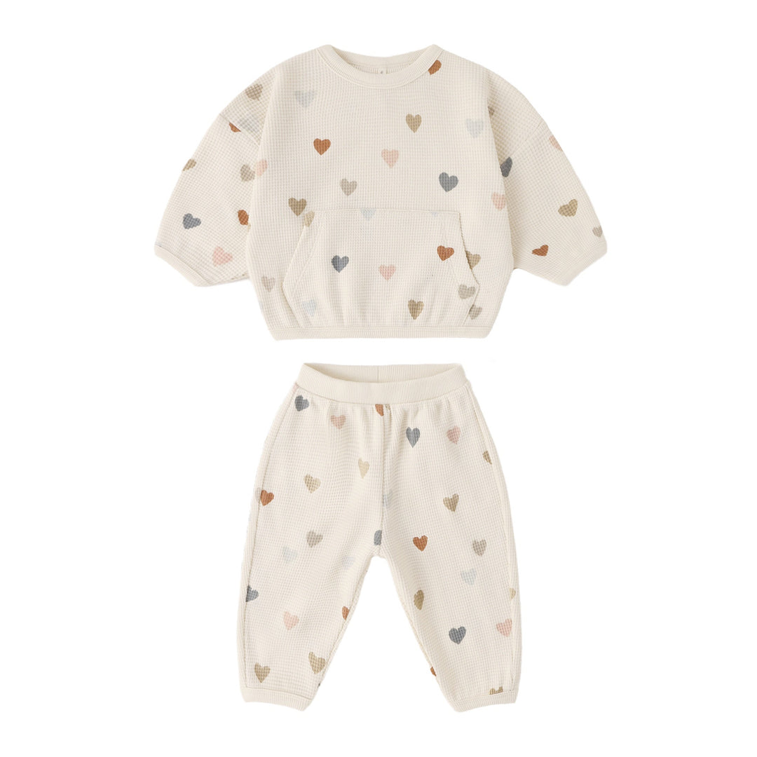 Children's outfit with heart pattern on a white background