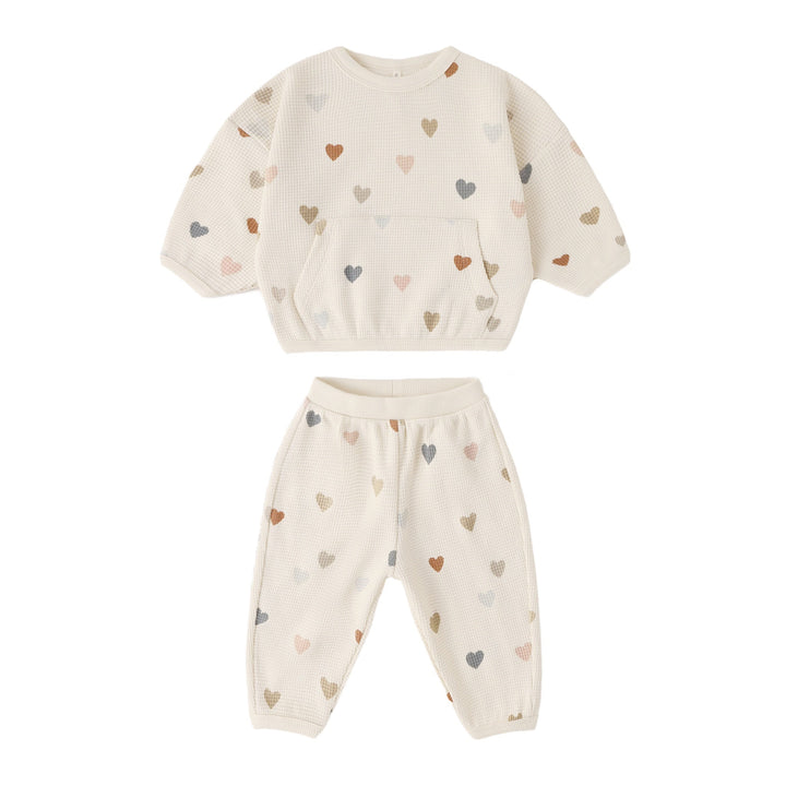 Children's outfit with heart pattern on a white background