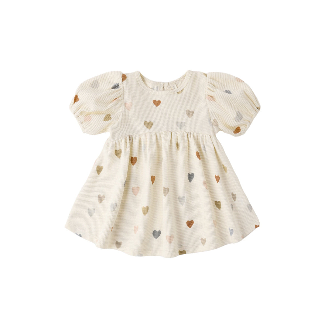 Baby dress with heart pattern on a white background