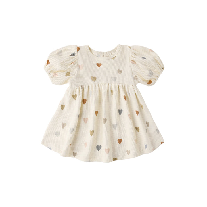 Baby dress with heart pattern on a white background
