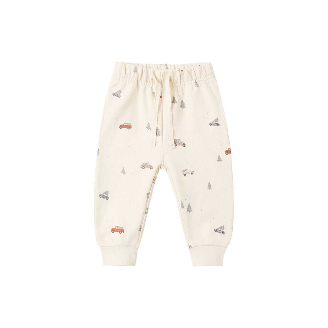 Off-white baby jogger pants with a small all-over print of vintage cars, trees, and birds, featuring an elastic waistband and drawstring.
