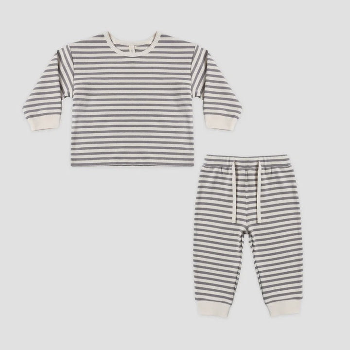 Striped children's outfit with shirt and pants on a white background