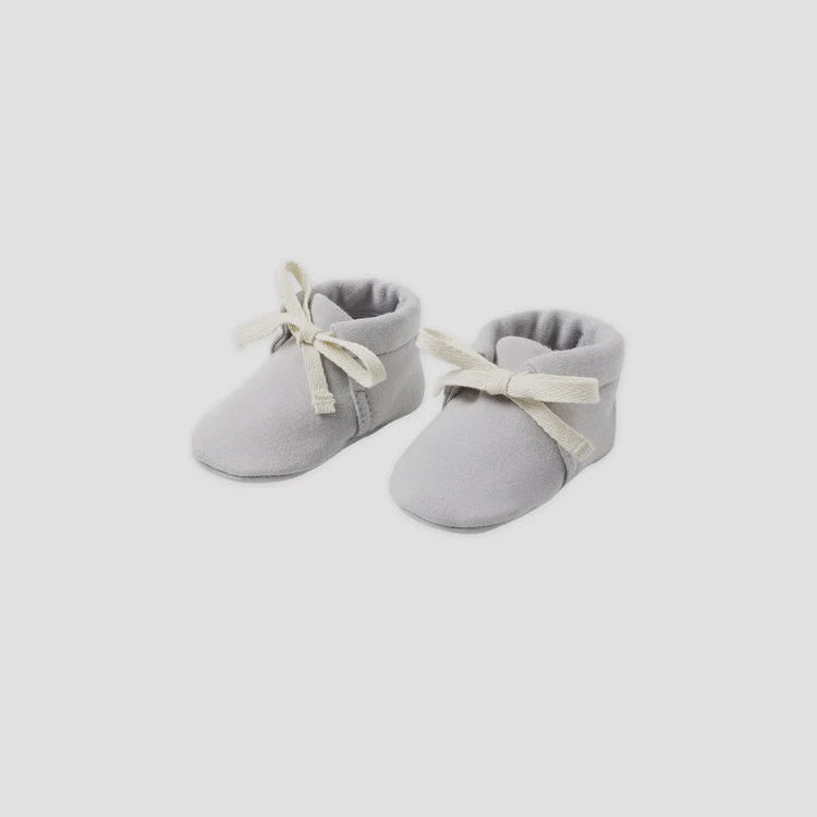 Pair of gray baby boots with white ribbons on a white background