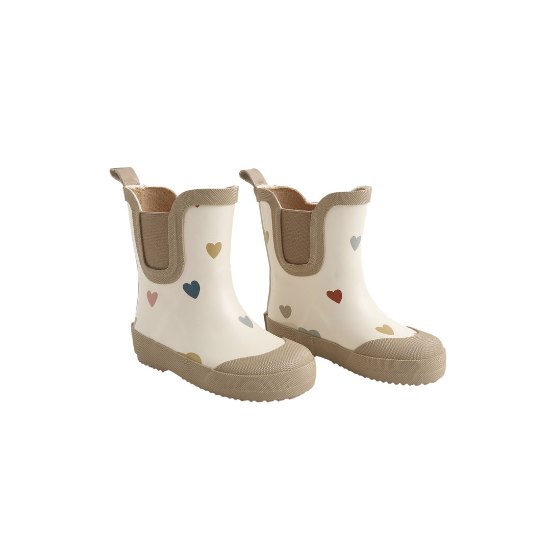 Pair of white rain boots with heart patterns on a white background