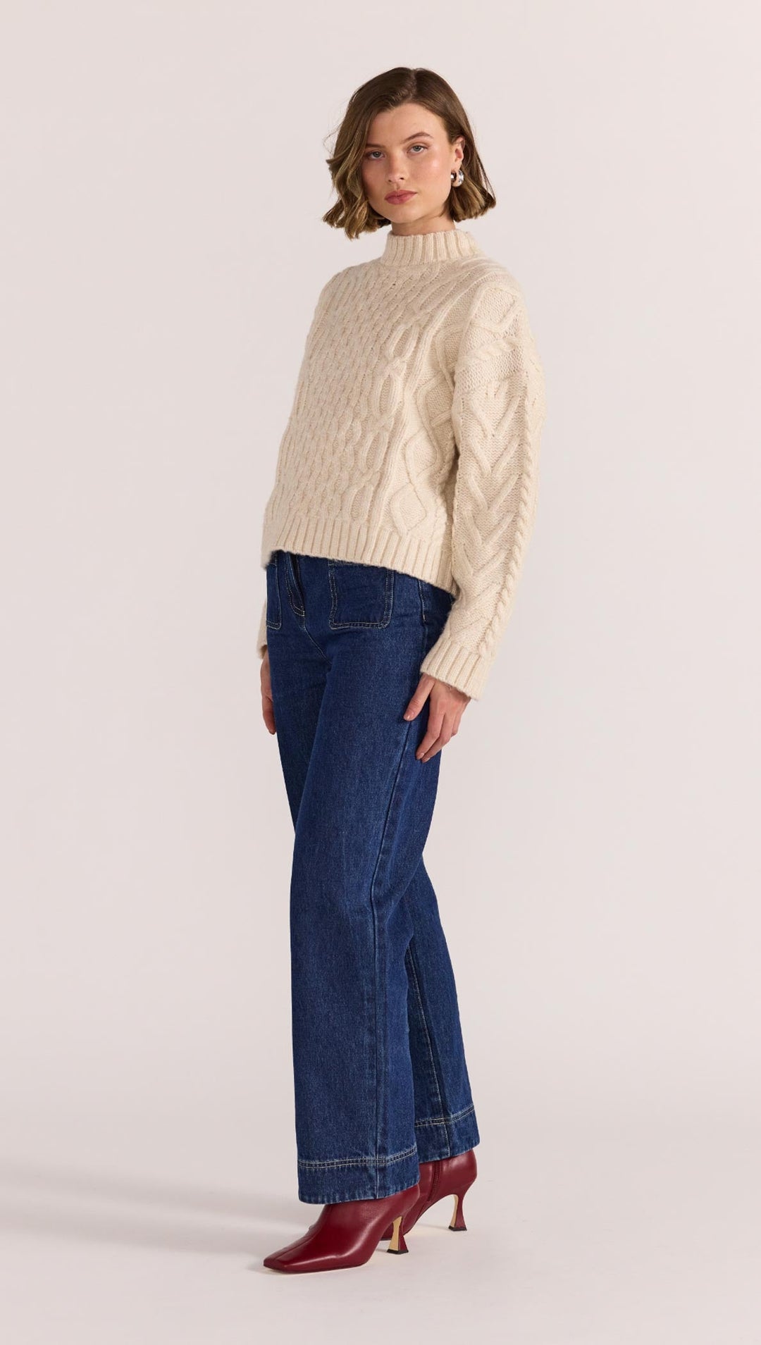 Chunky, cosy, and a cold-weather classic - the Rosina Cable Knit Jumper in cream is your go-to for elevated everyday warmth. Available from www.thecollectivenz.com