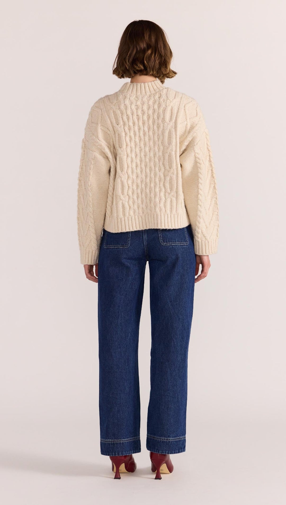 Chunky, cosy, and a cold-weather classic - the Rosina Cable Knit Jumper in cream is your go-to for elevated everyday warmth. Available from www.thecollectivenz.com