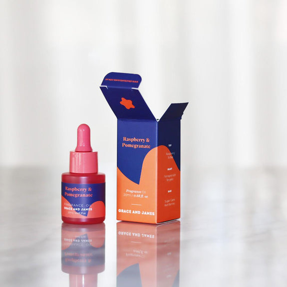 Raspberry & Pomegranate product with packaging on a reflective surface