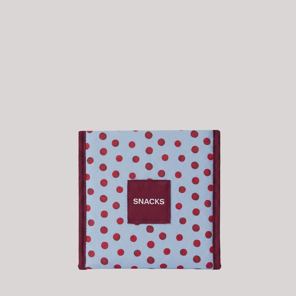 A square snack box with a light blue background, red polka dots, and a dark red front label that reads 'SNACKS' in white text, centered on a light gray background.