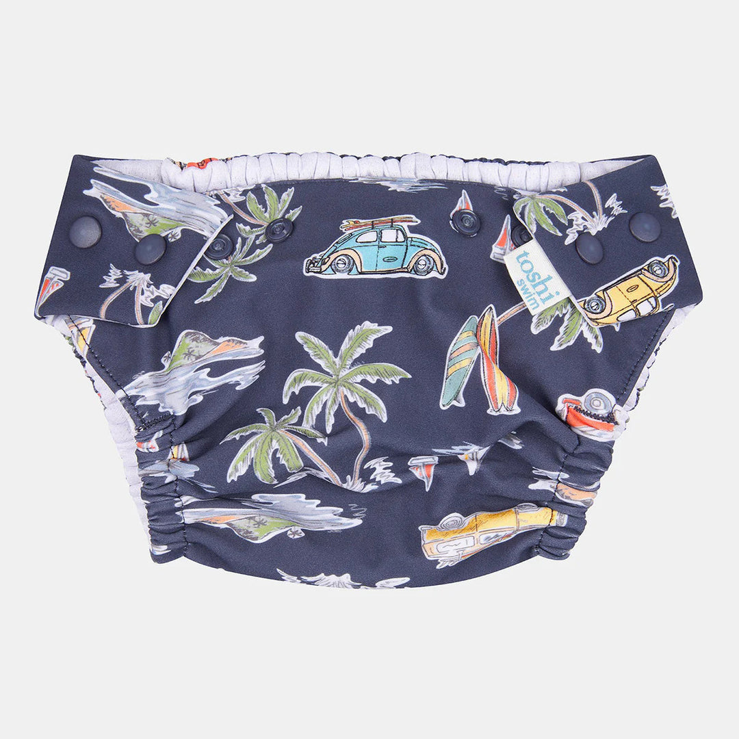Navy swim diaper with tropical print on a white background