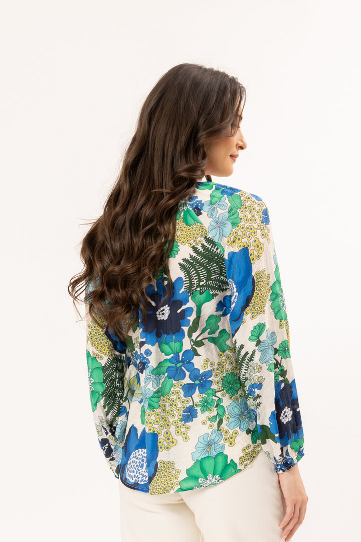 Woman wearing a floral blouse with a white background