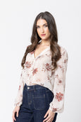 Woman wearing a floral blouse and jeans on a white background